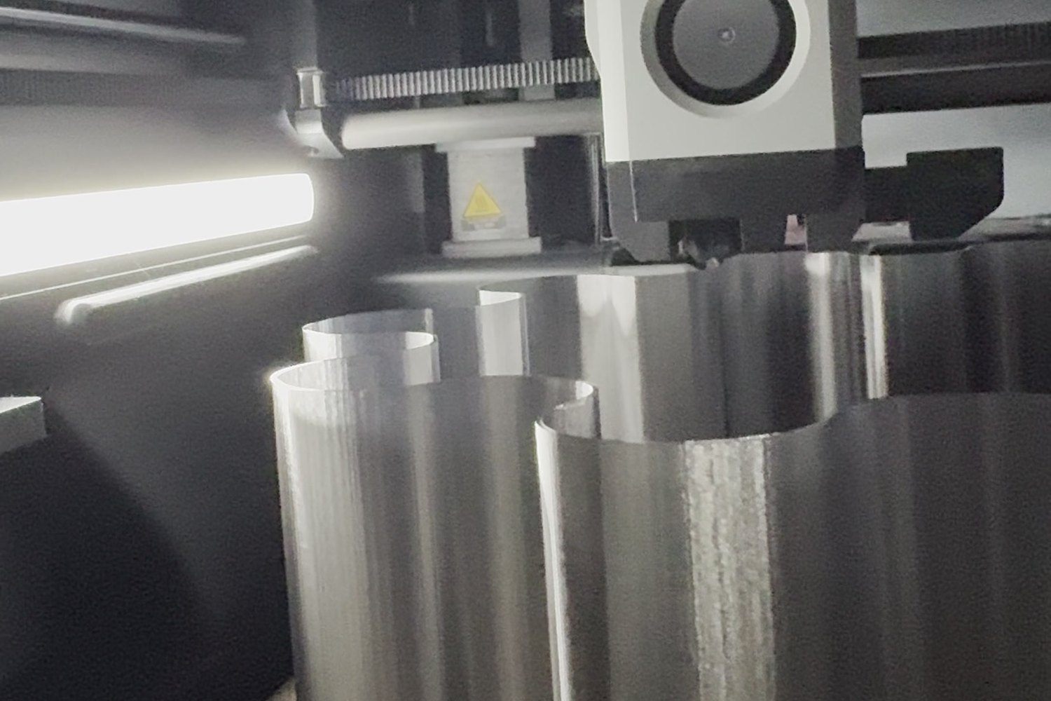 The print head over a silver wavy shade, mid-print