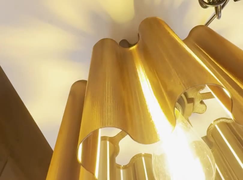 Hands fitting the bulb into a lamp, which lights up for its final check
